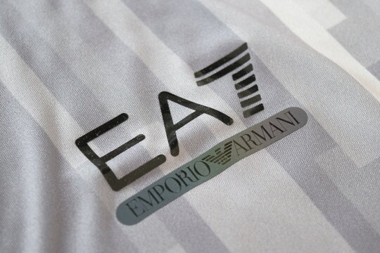 Close up of EA7 Emporio Armani printed logo on grey striped fabric