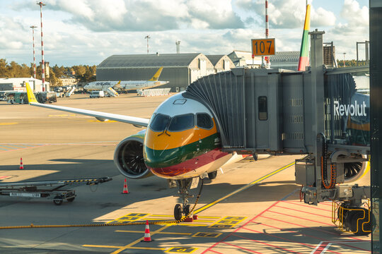 RIGA, LATVIA - SEPTEMBER 17, 2026: airBaltic Airbus A220-300 in Lithuanian flag special livery parked at gate 107 at Riga International Airport