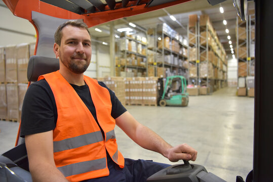 warehouse worker in a forwarding agency - interior with forklift - transport and storage of goods