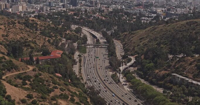Los Angeles California Aerial v284 zoomed flyover capturing Hwy 101 passing through hills neighborhoods and downtown cityscape on the skyline - Shot with 5k Camera - May 26th 2024