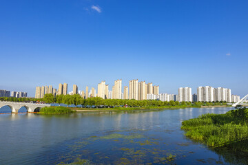 Urban skyline with river, bridge, and high-rise apartments © DinhBaoTran