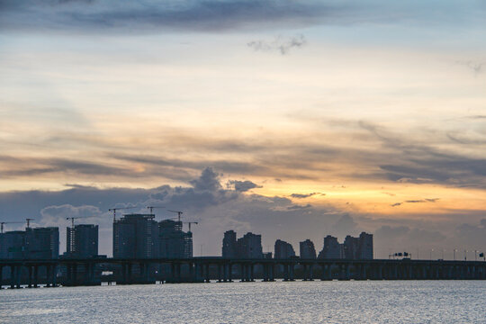 City skyline and bridge at sunset over water