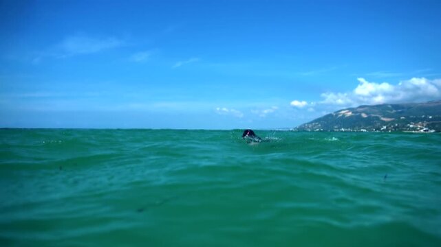 Swimmer Practicing Freestyle In Open Deep Sea. Triathlon Training Endurance Workout 
