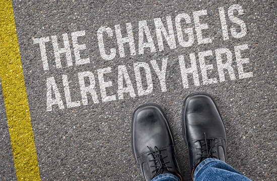 Text on the road - The Change Is Already Here
