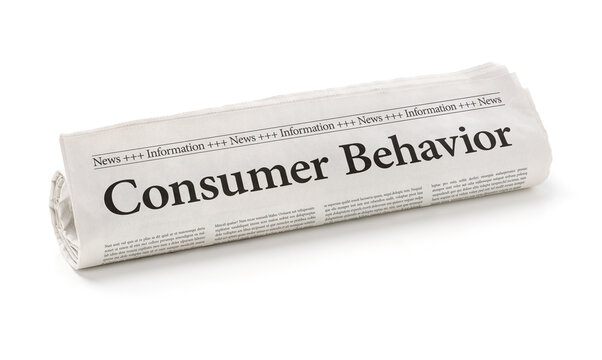 Rolled newspaper with the headline Consumer Behavior