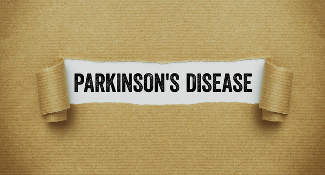 Torn paper revealing the word Parkinson's disease