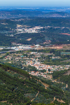 A high-angle panoramic view shows scattered settlements