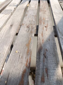Close up perspective view of old weathered wooden planks with rusty nails