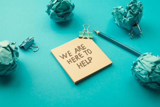 We are here for help, message on sticky note with paper clip