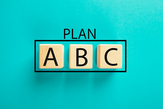 The word ABC is written on wooden cubes on a blue background.