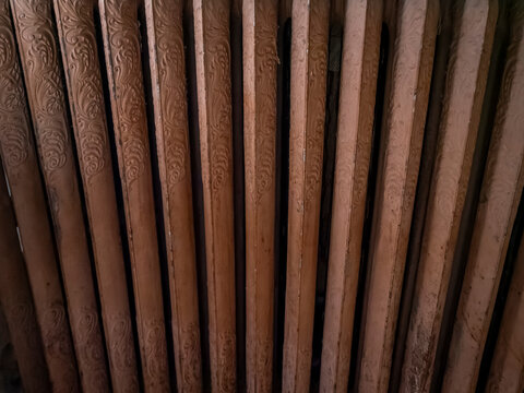 Detailed close up view of an ornate vintage cast iron radiator with intricate floral and scroll relief patterns in an old home interior