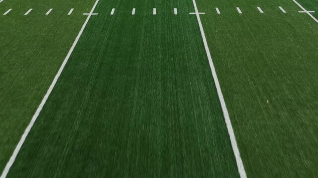 American football field low POV flyover showing side line and hash marks