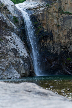 Waterfall Falling Into Rocky Mountain Pool