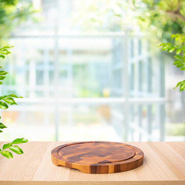 Selective focus.Wood table top with wood chopping board with blur glass wall