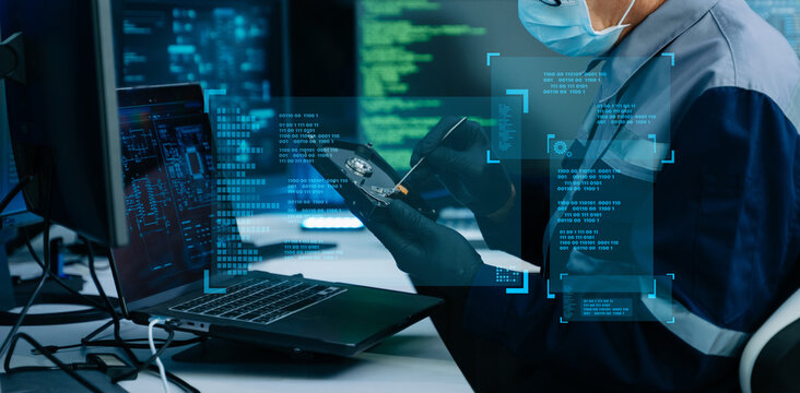 A masked IT engineer repairs a hard drive using tweezers. Glowing binary code and digital HUD overlays highlight advanced data recovery, cybersecurity