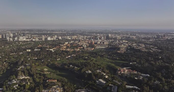 Los Angeles California Aerial v303 reverse flyover Bel Air, capturing hillside mansions, golf course and Westwood cityscape - Shot with 5k Camera - May 26th 2024