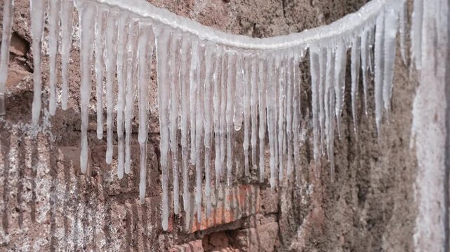 Icicles form on a rope in cold weather mountain park, perfect for seasonal video