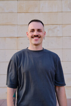 Smiling latino man standing outdoors looking at camera