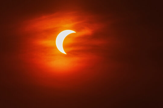 Partial solar eclipse over valldemossa sky in Mallorca Spain