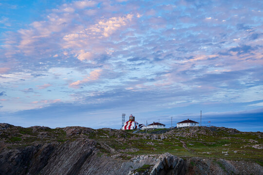 Cape Bonavista lighthouse at Sunset on rocky hill in Bonavista