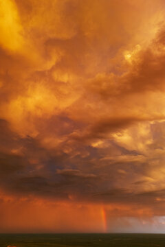 Storm clouds with rainbow at Sunset over uvalde plains