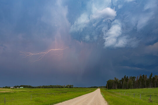 Lightning storm along a rural farm road in ponoka county alberta
