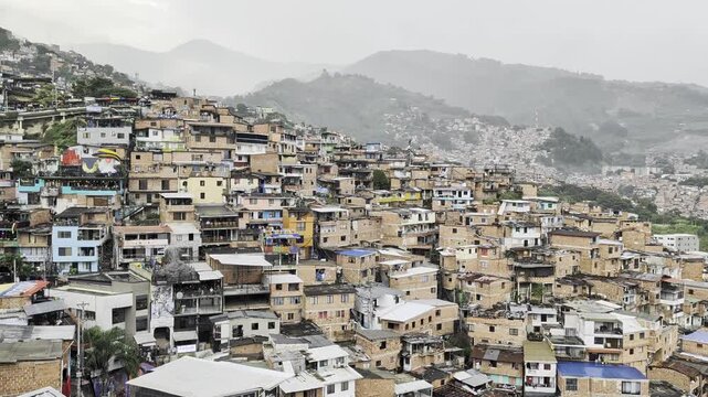 View of Tour Comuna 13 with its dense hillside brick houses and steep urban landscape in Medellin, Antioquia, Colombia.