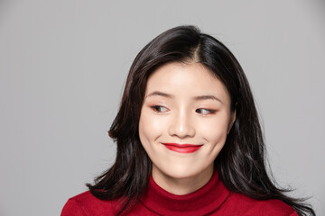 Fototapeta premium Smiling Young Asian Woman With Long Dark Hair and Red Lipstick