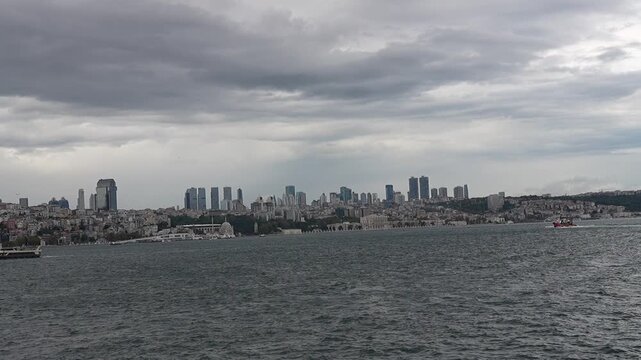 ISTANBUL, TURKEY - SEPTEMBER 23, 2026: Passenger ferry sailing on the Bosphorus Strait in Istanbul with scenic clouds, seagulls, and city skyline in the background.