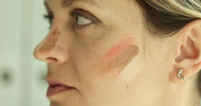 In a bright, modern setting, diverse foundation shades are expertly tested on the skin to showcase their effectiveness in achieving a natural look.