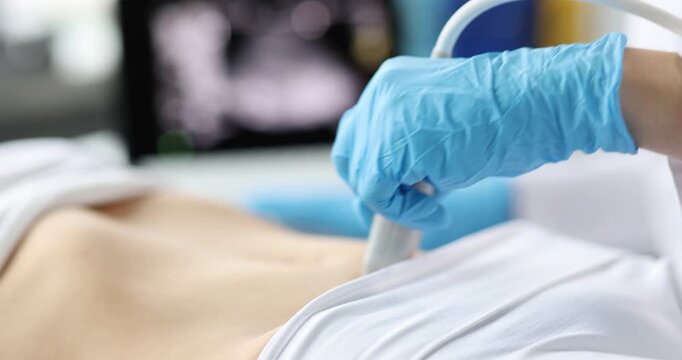 A skilled medical professional conducts an ultrasound examination on a patient s abdomen, gently moving the transducer.