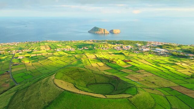 Pico Dona Joana Volcanic Cone, Patchwork Fields, Pasturelands and Cabras Islets at Sunset. Atlantic Ocean. Terceira Island, Azores, Portugal. Aerial View. Moving Forward