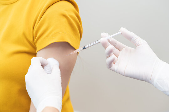 Health care, corona virus, hand of woman nurse, doctor giving syringe vaccine, injection dose on arm sick patient at clinic. Vaccination, immunization disease prevention against flu pandemic influenza