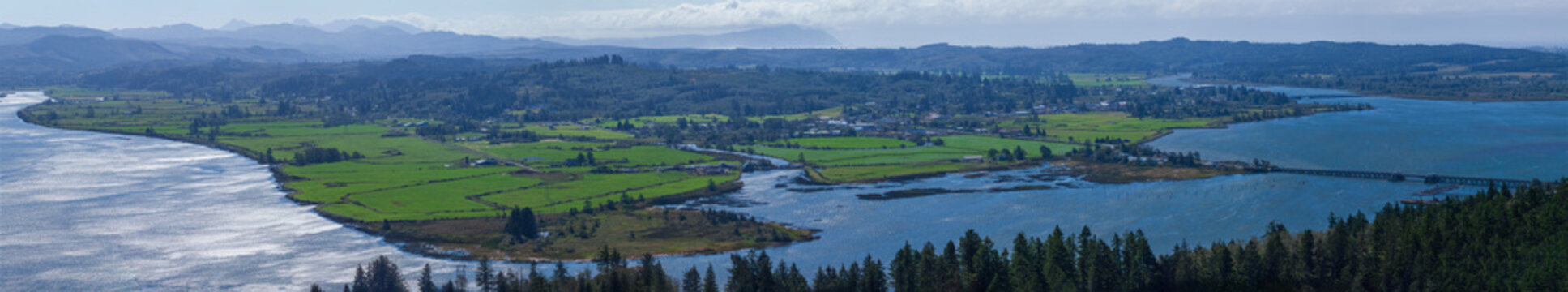 Beautiful wide panoramic view of green valley with rivers and mountains