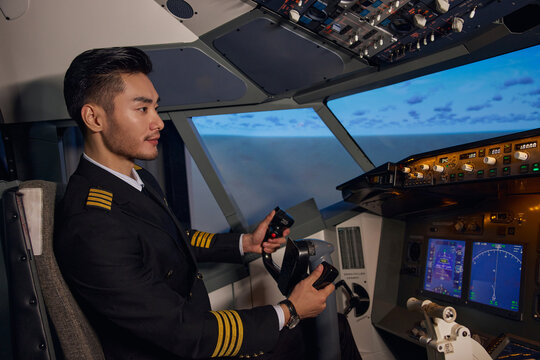 Airline Pilot Controlling Aircraft in Cockpit