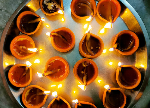 Glowing Clay Diyas on Plate for Diwali Celebration