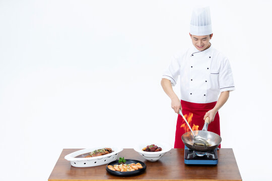 Smiling Chef Cooking with Flaming Wok