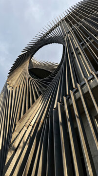 Twisted metal lamella tower spirals into an abstract geometric architectural form