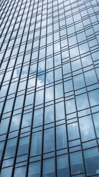 Reflective glass curtain wall grid forms a vertical abstract downtown skyline pattern