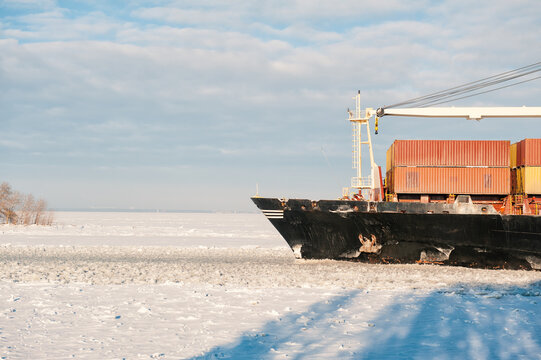 Winter shipping. Big cargo ships in ice sea fairway