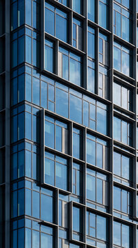 Layered glass grid facade forms a crisp geometric abstract downtown pattern