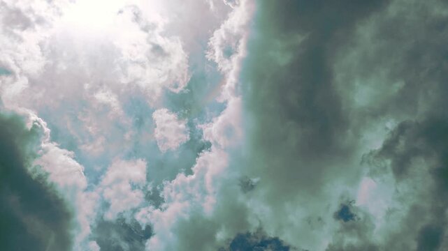 Stormy clouds moving through sky with sun rays filtering through, dynamic weather footage, dramatic atmospheric background for storytelling and visual effects.