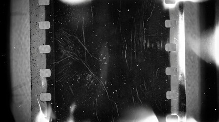 Fototapeta premium Old film texture with scratches, noise and light leaks. Realistic transparent overlay film texture in black-white, dust and grain. Distressed retro movie or photo negative effect of cinema nostalgia