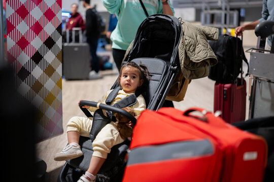 Toddler traveling by air in airport terminal