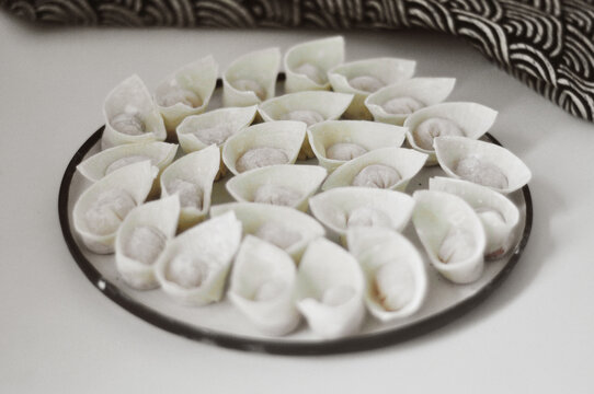 Closeup of freshly made, homemade wontons on a plate