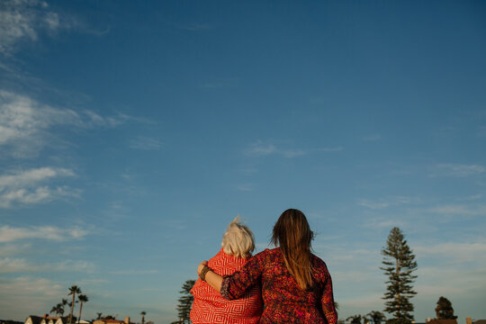 Mother and Adult Daughter Embracing While Looking at California Sky