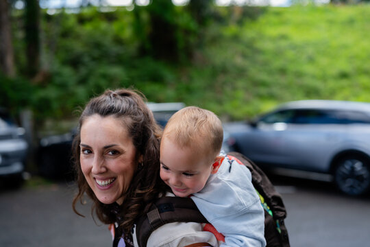 Mother carrying son in baby carrier