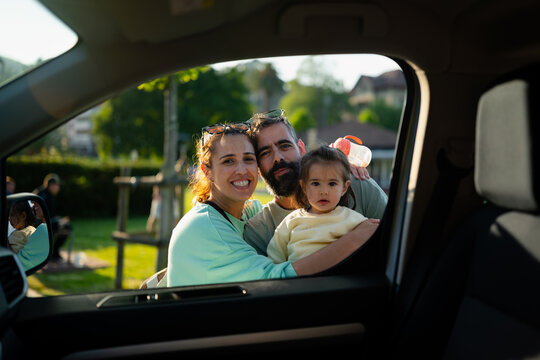 Family enjoying travel by car with child smiling