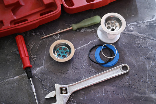 Tools and a small wooden table in a room with a cabinet and a curtain