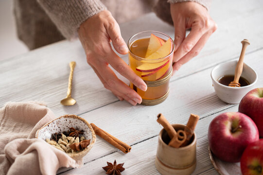 Mulled cider in female hands, fall hygge beverage
